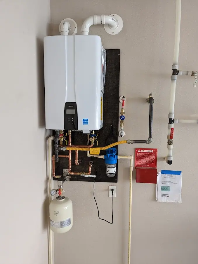 Professional plumber installing copper piping in a Romulus home